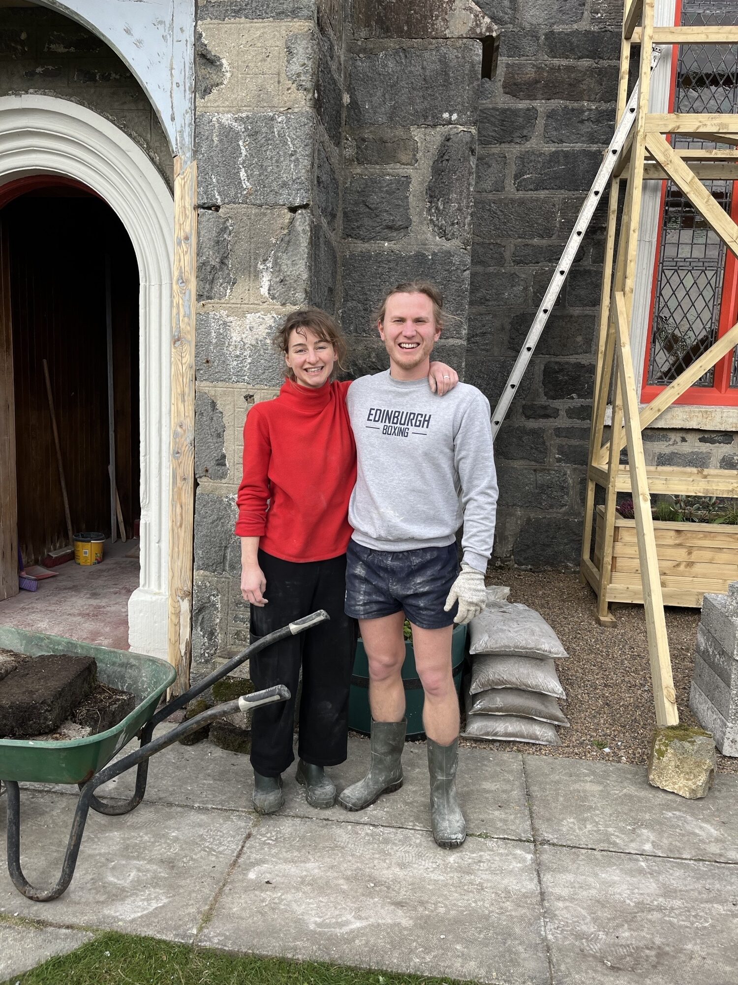 Kate and Andrew standing outside their home